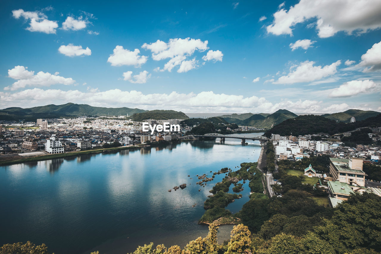 High angle view of river by town against sky