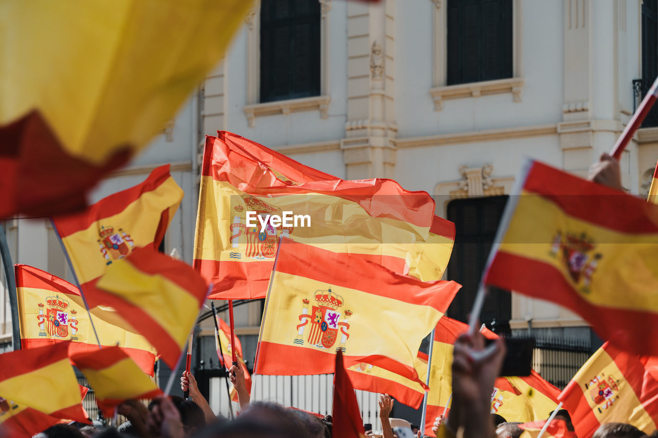 Hundreds of people demonstrating with flags of spain