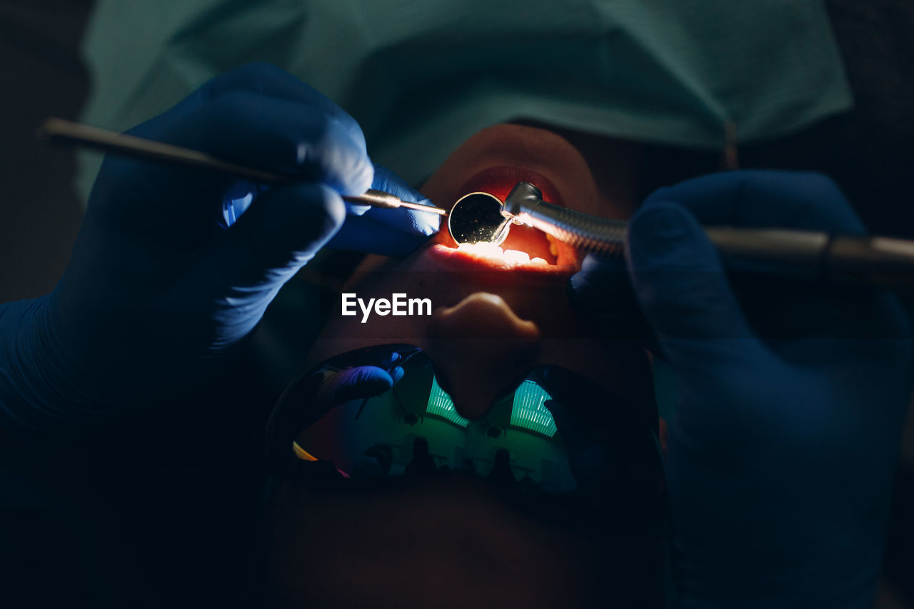 Close-up of dentist checking patient