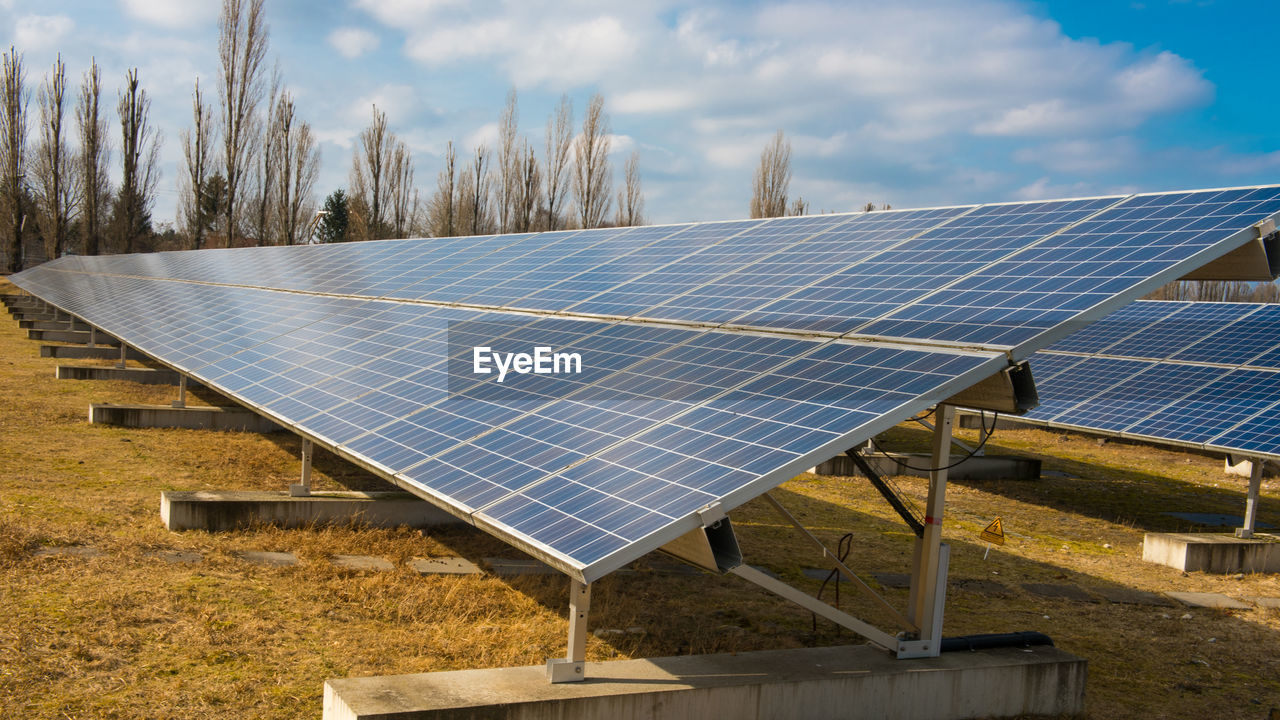 Tilt image of solar panels against sky