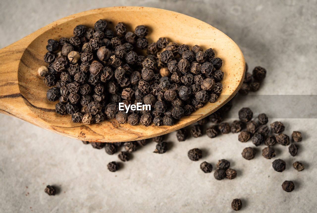 High angle view of black peppercorns on table