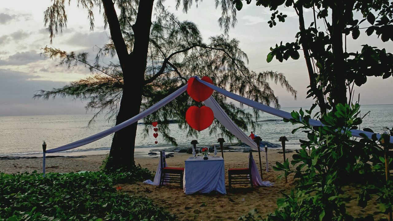 Heart shape decorations over dinning table at beach