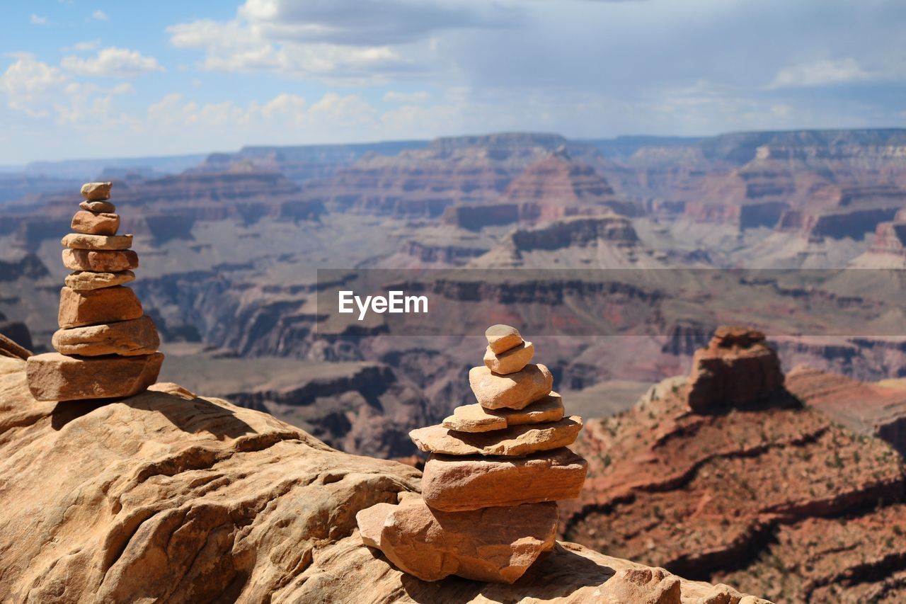 Close-up of stack of stones against rocky landscape