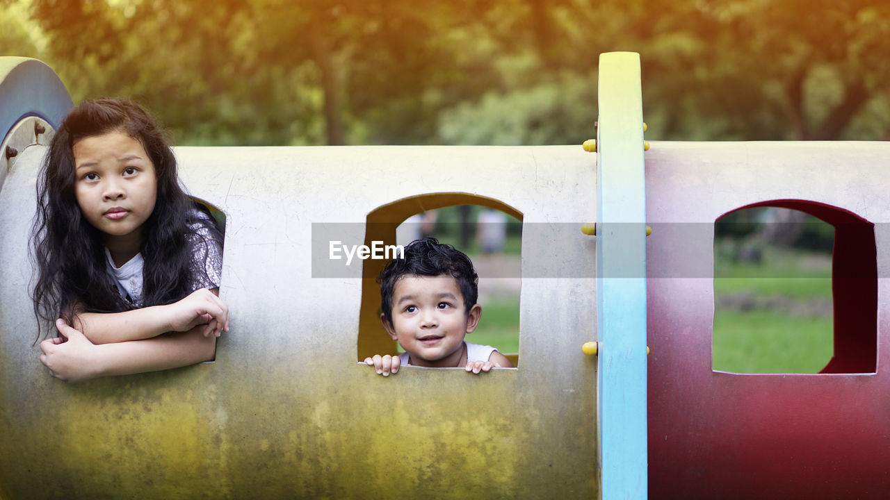 Cute sibling playing in playground