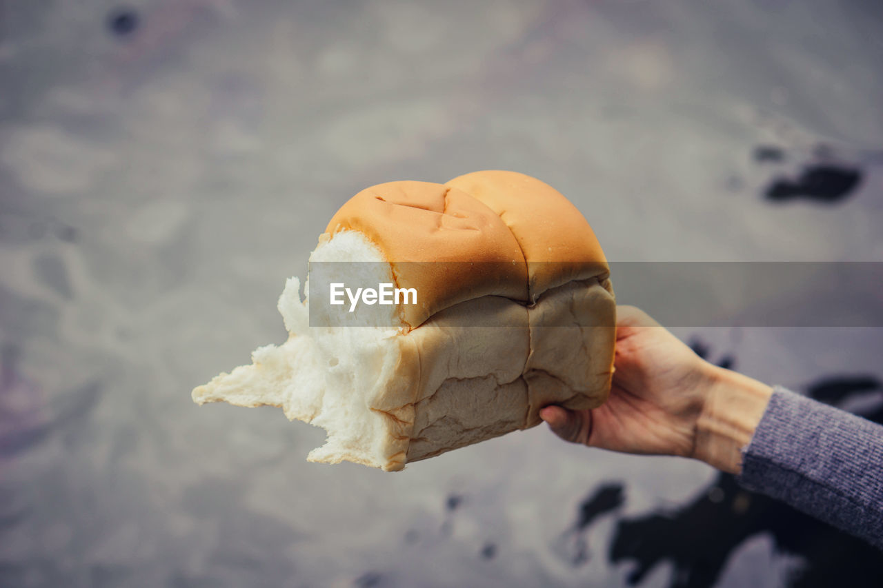 MIDSECTION OF PERSON HOLDING ICE CREAM CONE