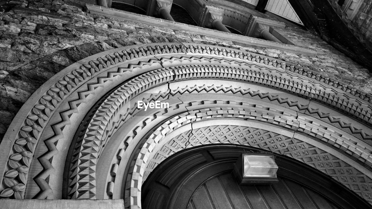 Low angle view of stone carvings on archway of spring grove cemetery