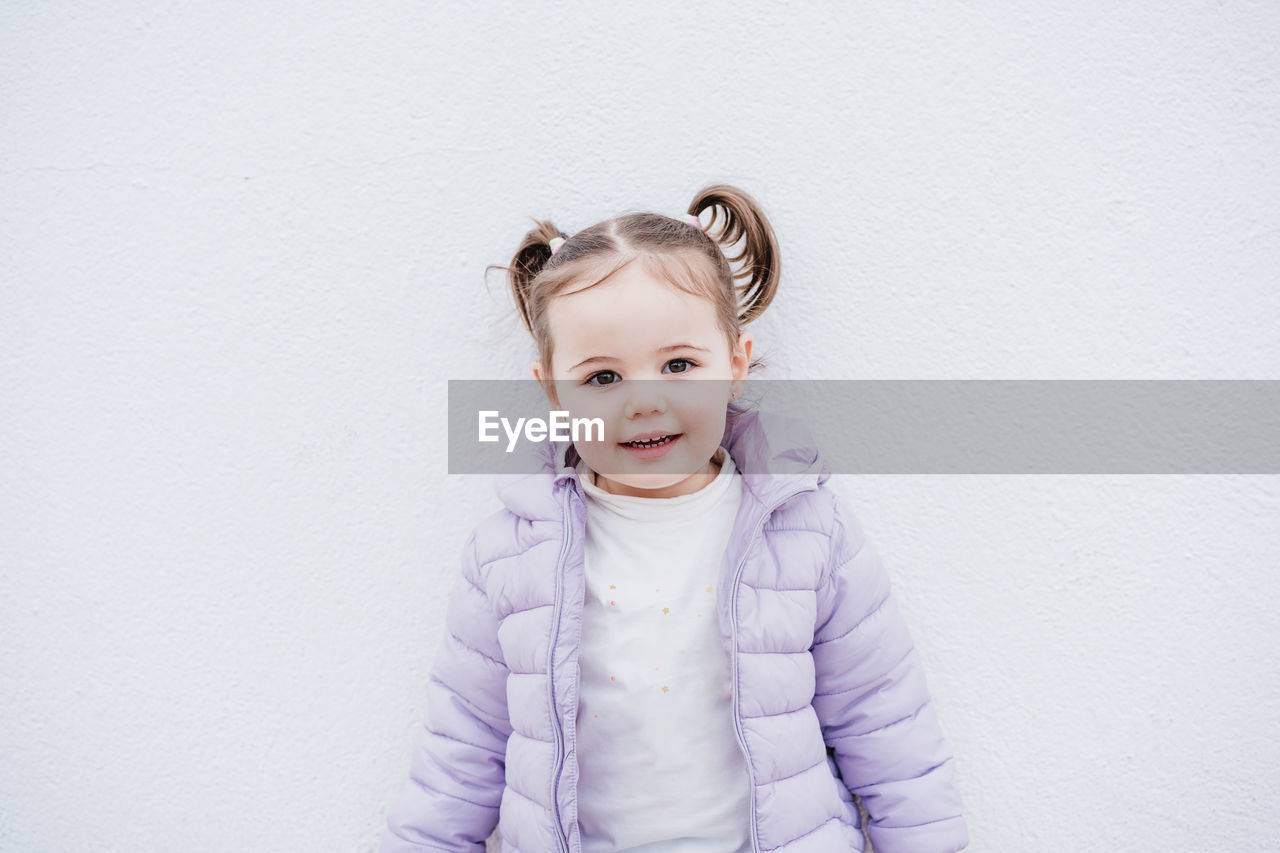 Portrait of beautiful caucasian two year old baby girl smiling over white background. childhood