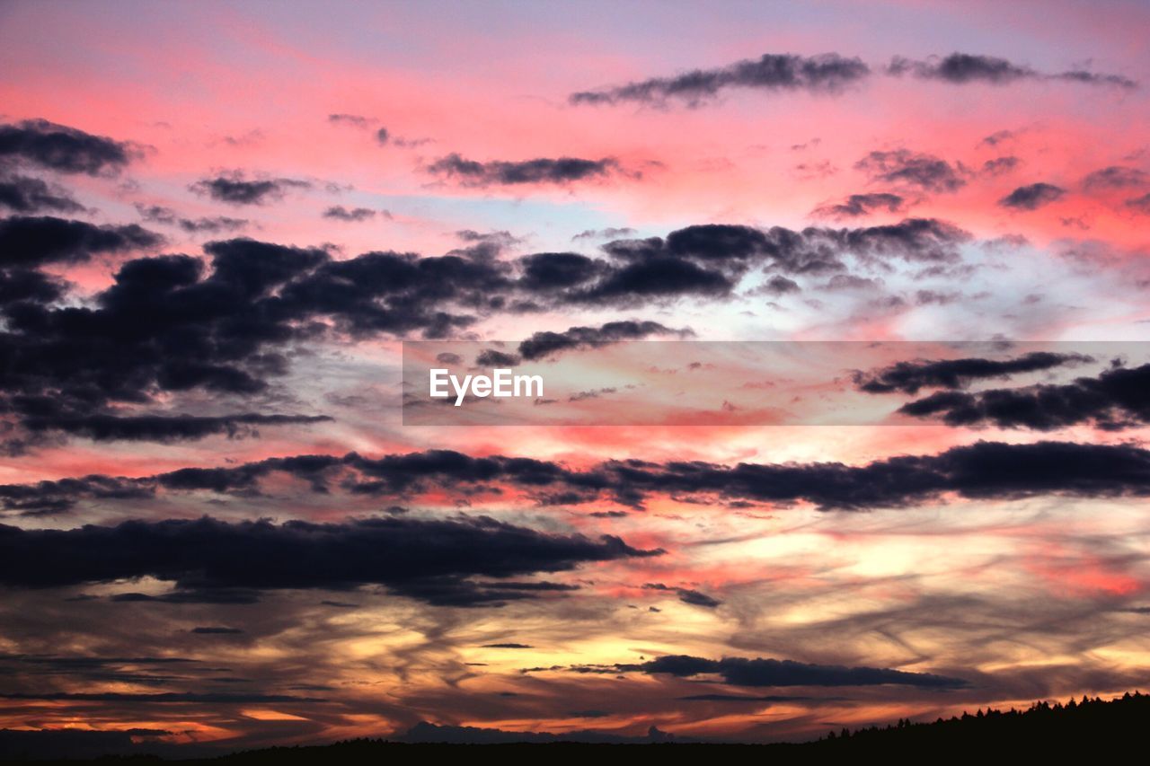 Low angle view of dramatic sky during sunset