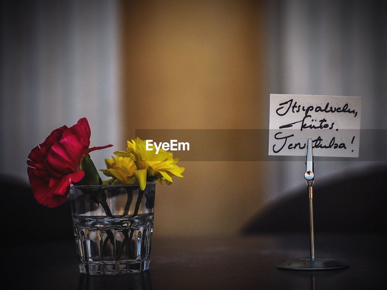 Flowers in glass by text on table