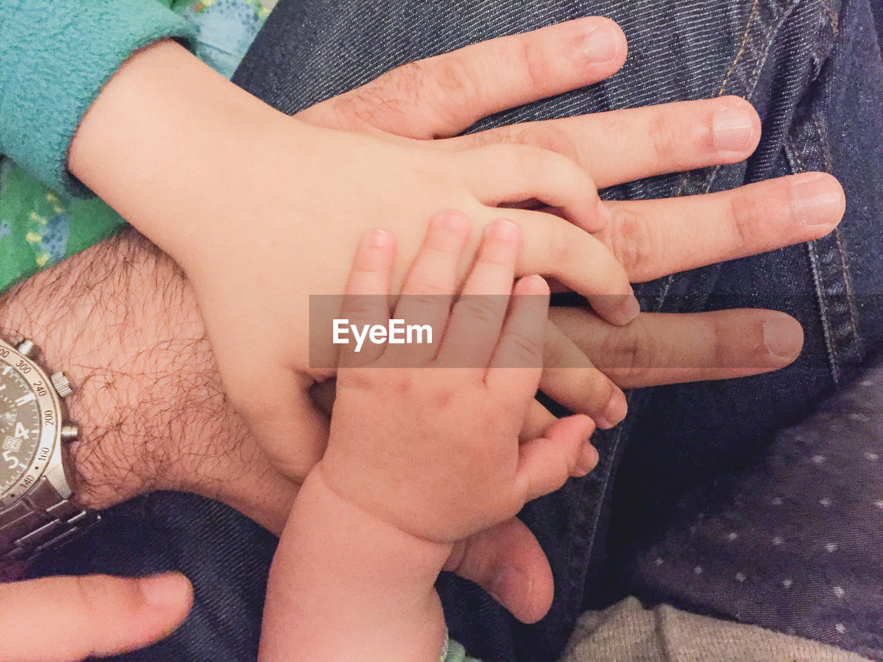 Cropped image of family with stacked hands