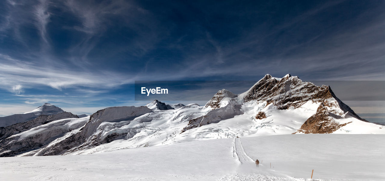 Scenic view of snow covered mountains against sky