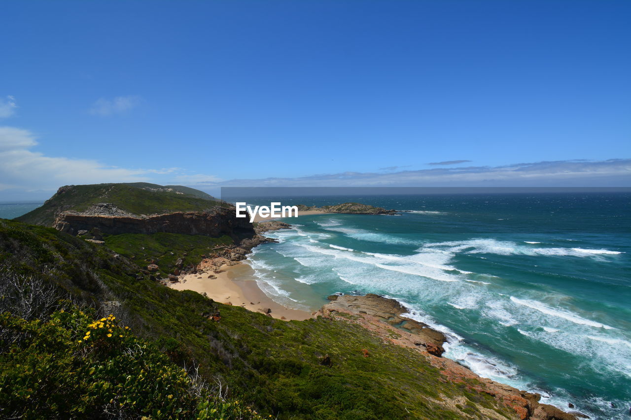 Scenic view of sea against blue sky