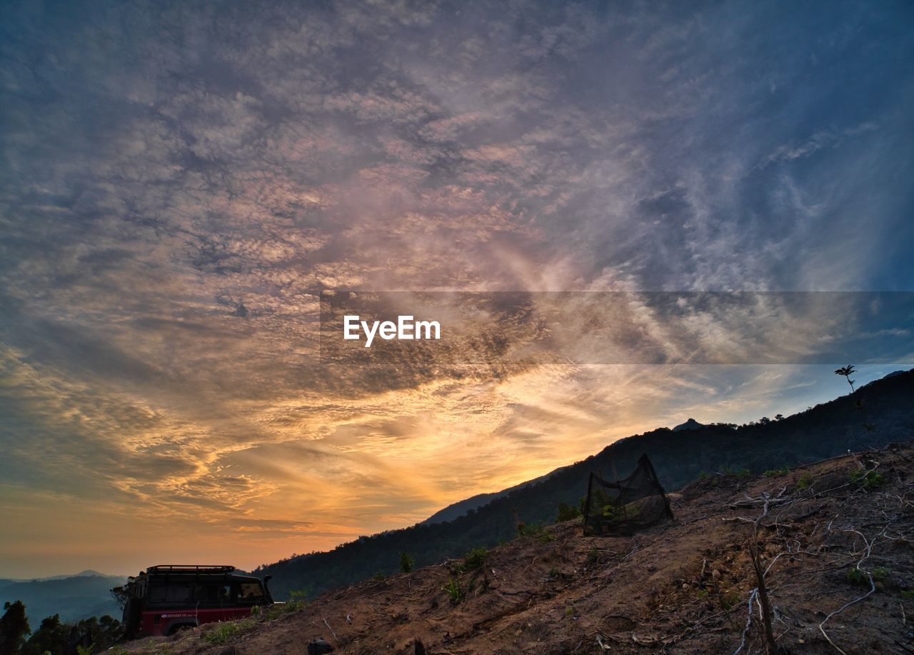 Low angle view of landscape against sky during sunrise at mountain area in asahan, melaka, malaysia.