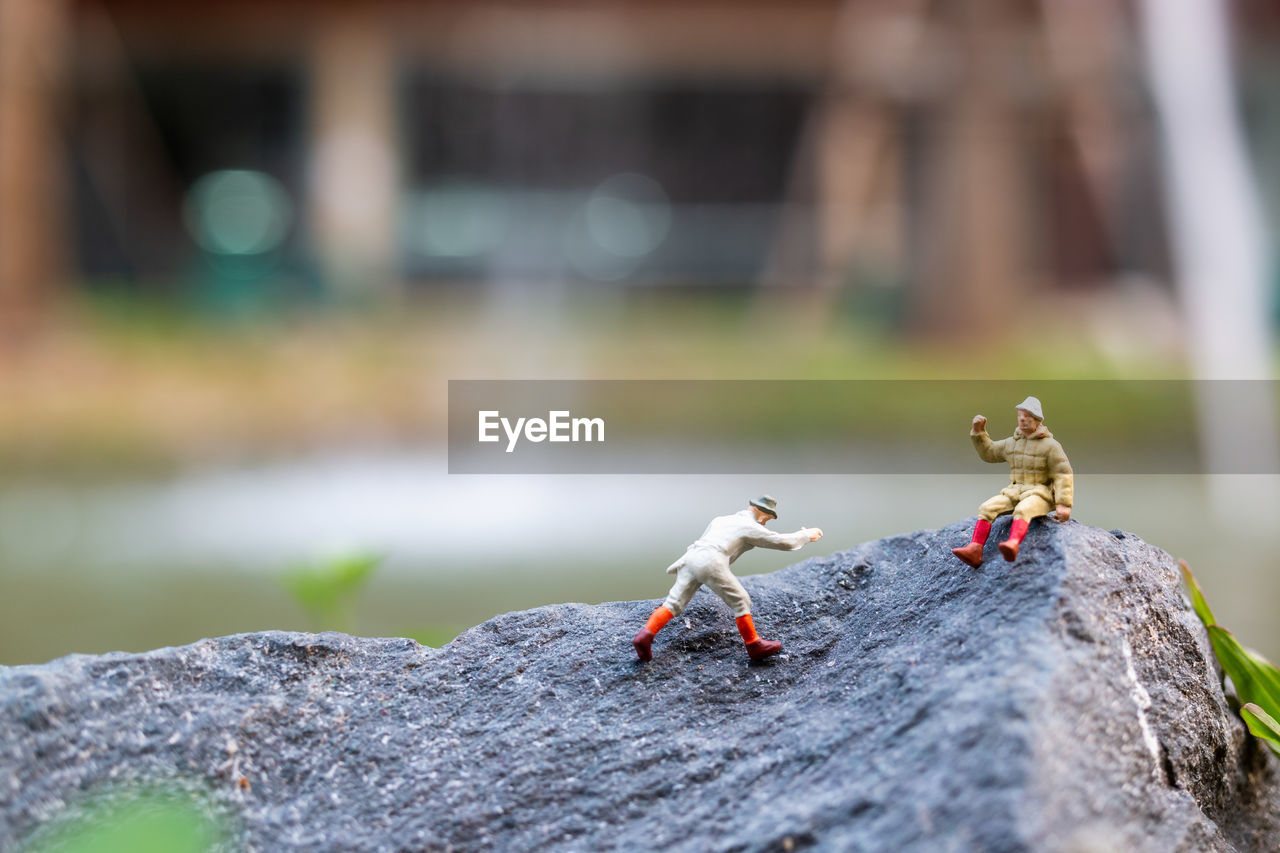 Close-up of figurine on rock