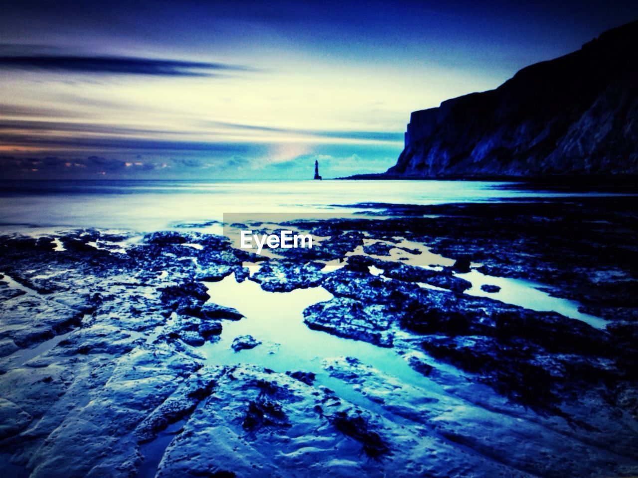 Calm and scenic beach against sky