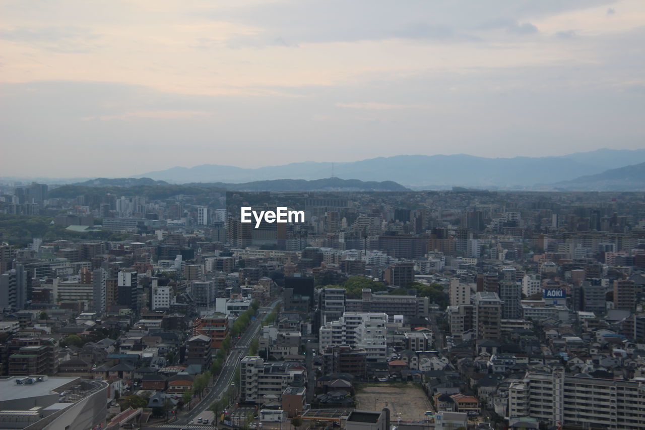 High angle view of buildings in city against sky during sunset