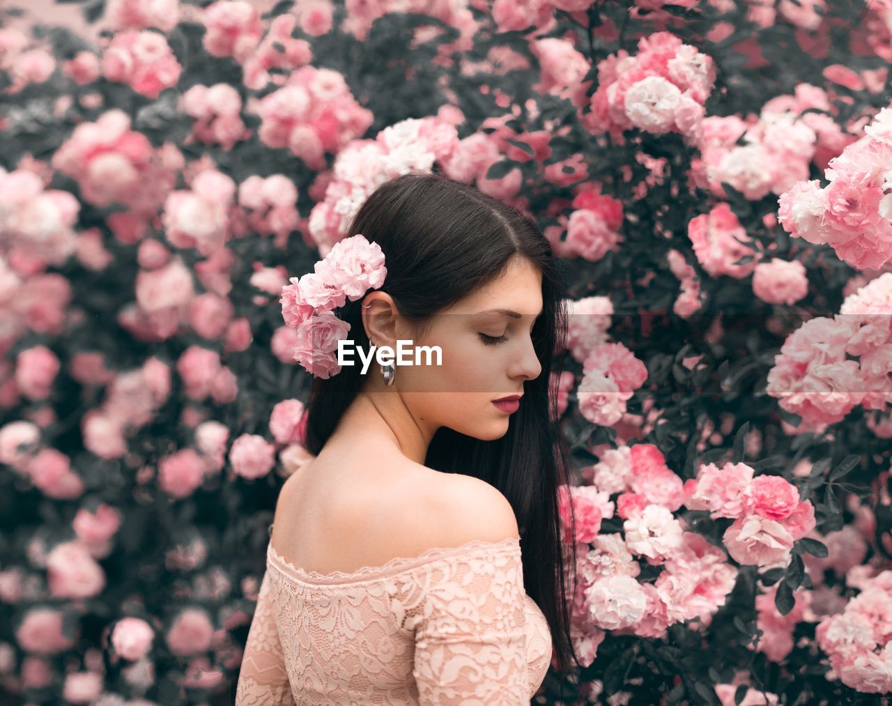 PORTRAIT OF BEAUTIFUL WOMAN WITH PINK FLOWERS
