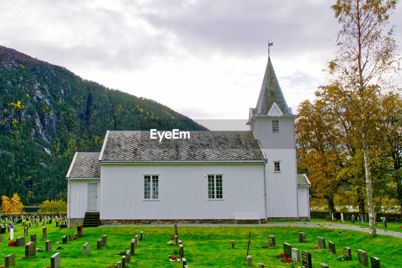 White, wooden church with slate roof in a norwegian valley 