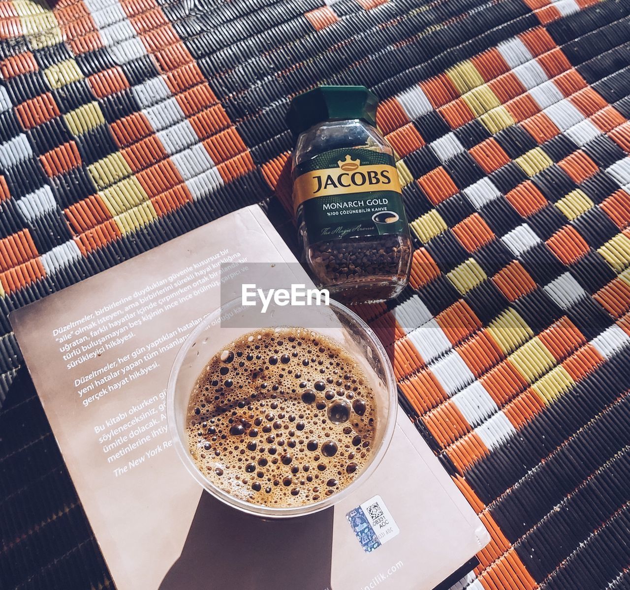 HIGH ANGLE VIEW OF COFFEE WITH TEXT ON TABLE