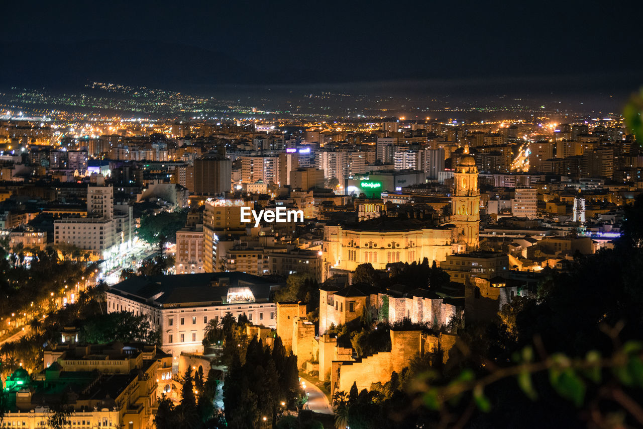 High angle view of illuminated buildings in málaga city at night