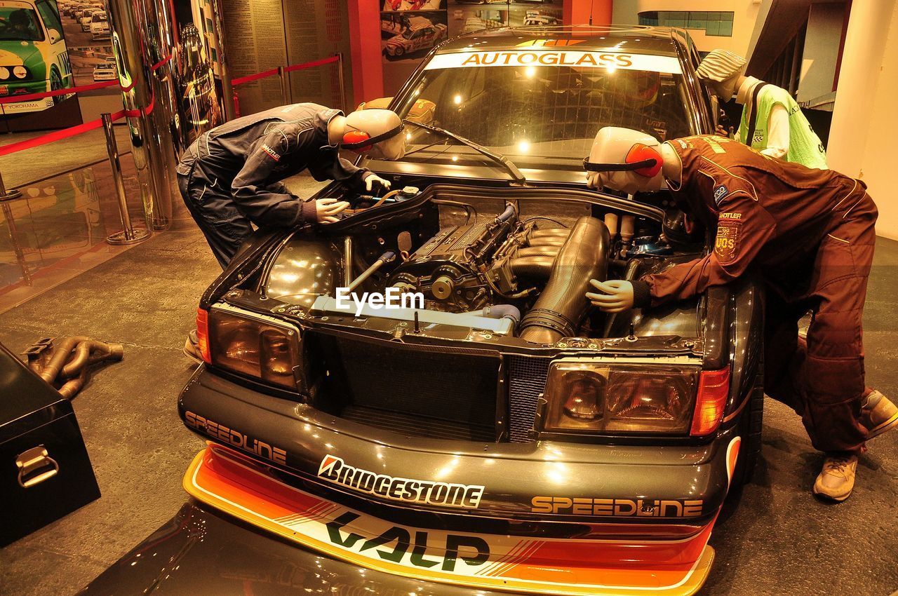 MAN WORKING IN VINTAGE CAR