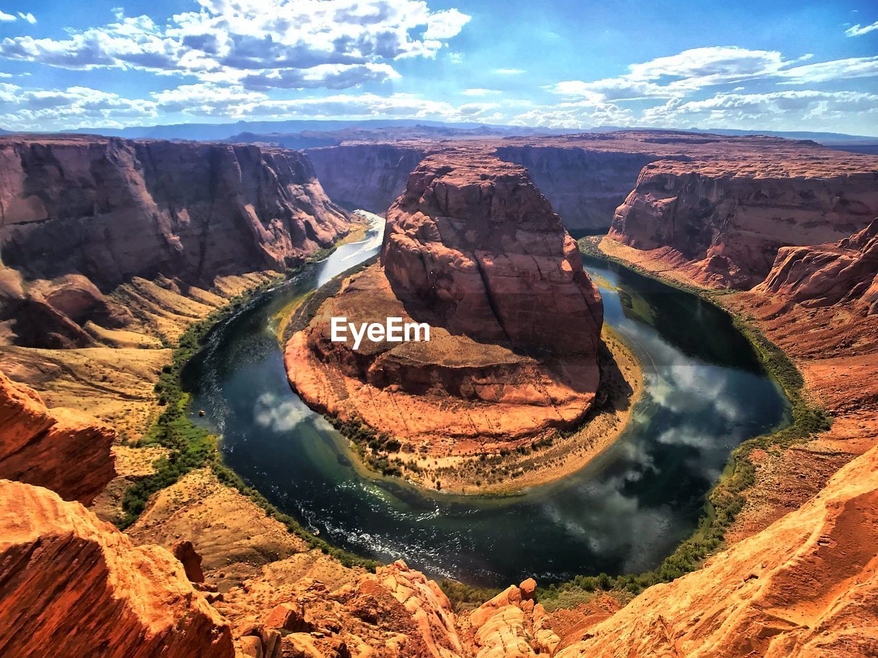 Aerial view of rock formations against cloudy sky