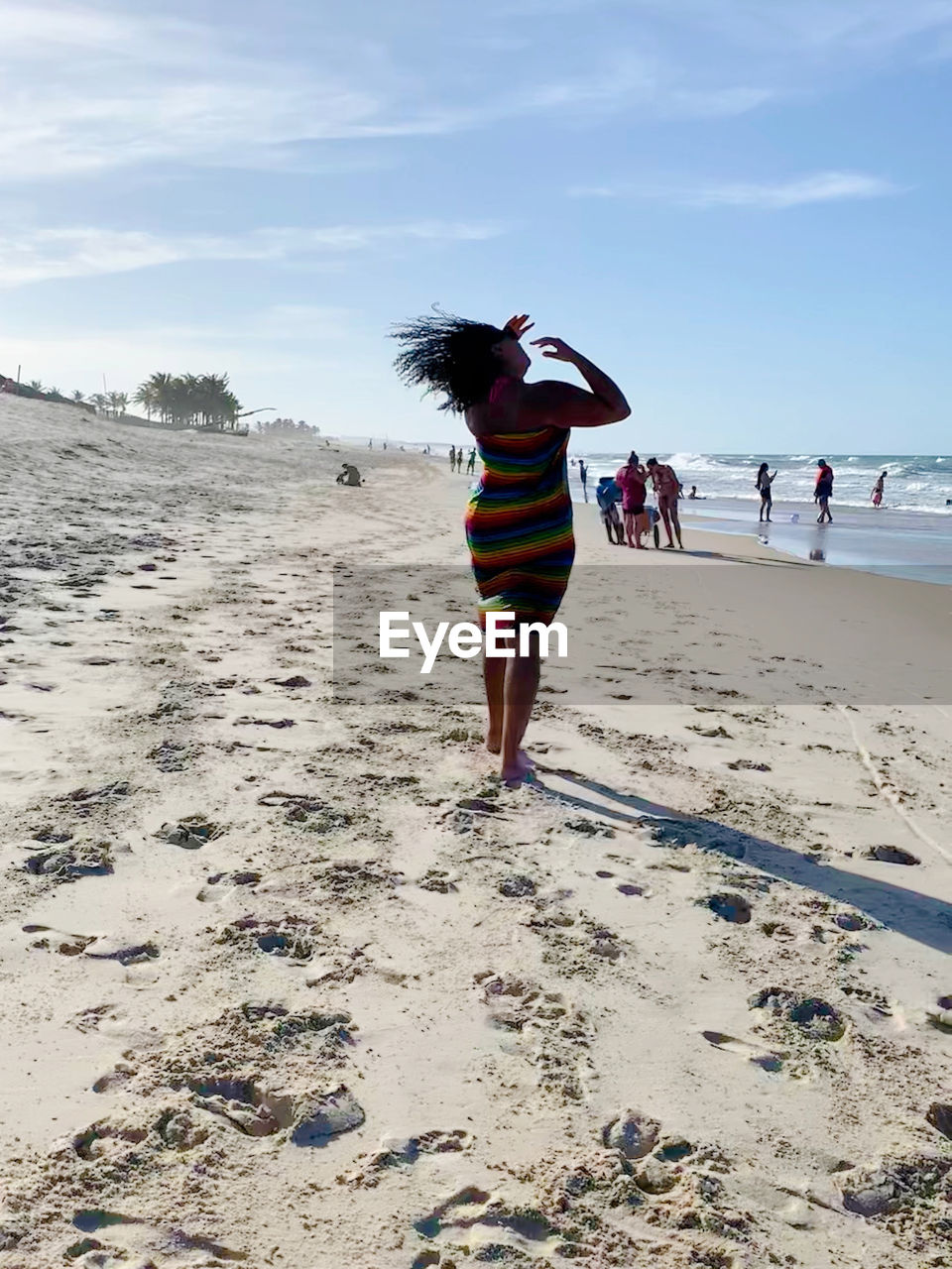 REAR VIEW OF WOMAN ON BEACH