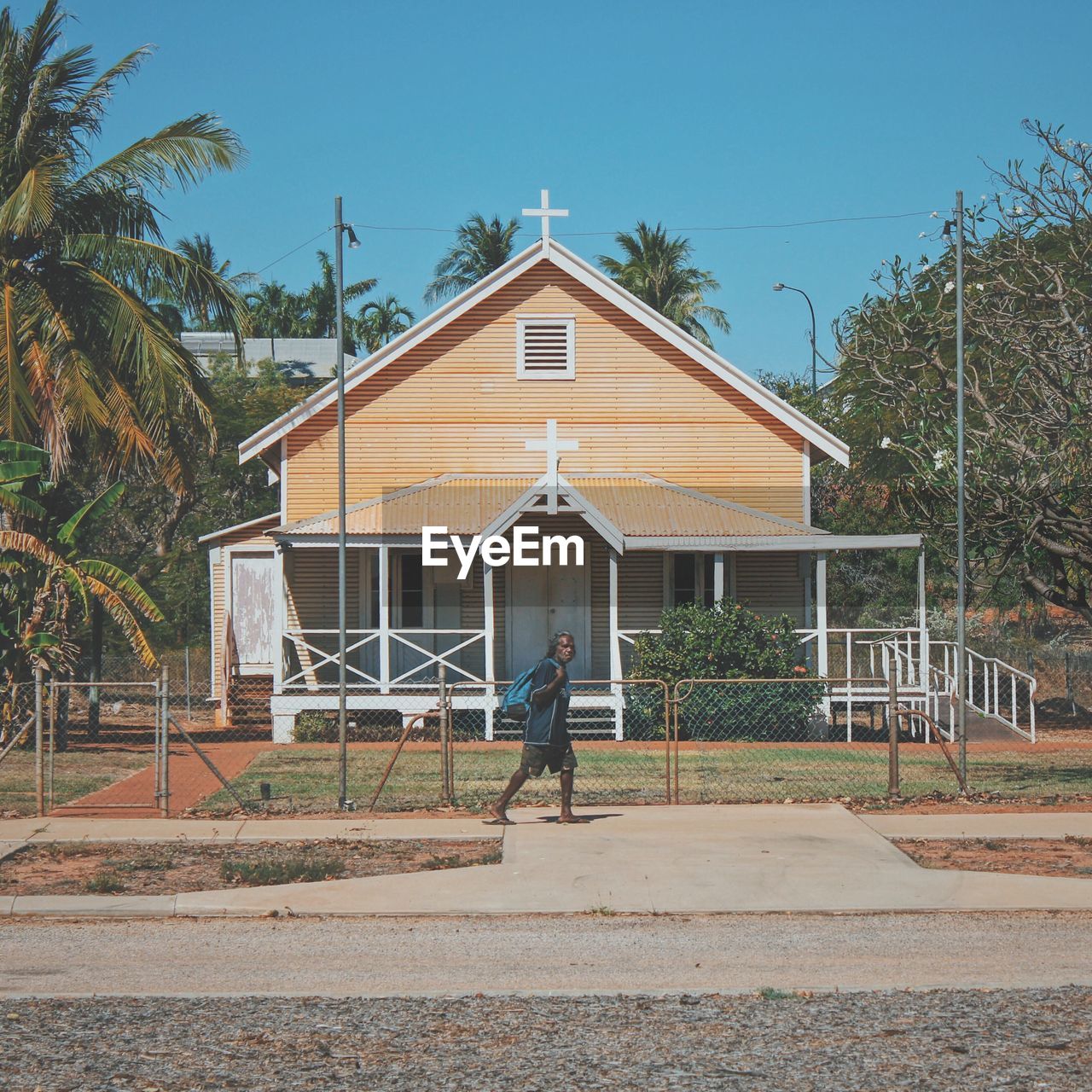 REAR VIEW OF MAN OUTSIDE HOUSE