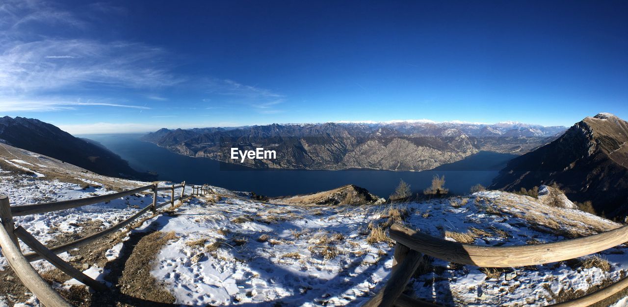 Panoramic view of snowcapped mountains against blue sky