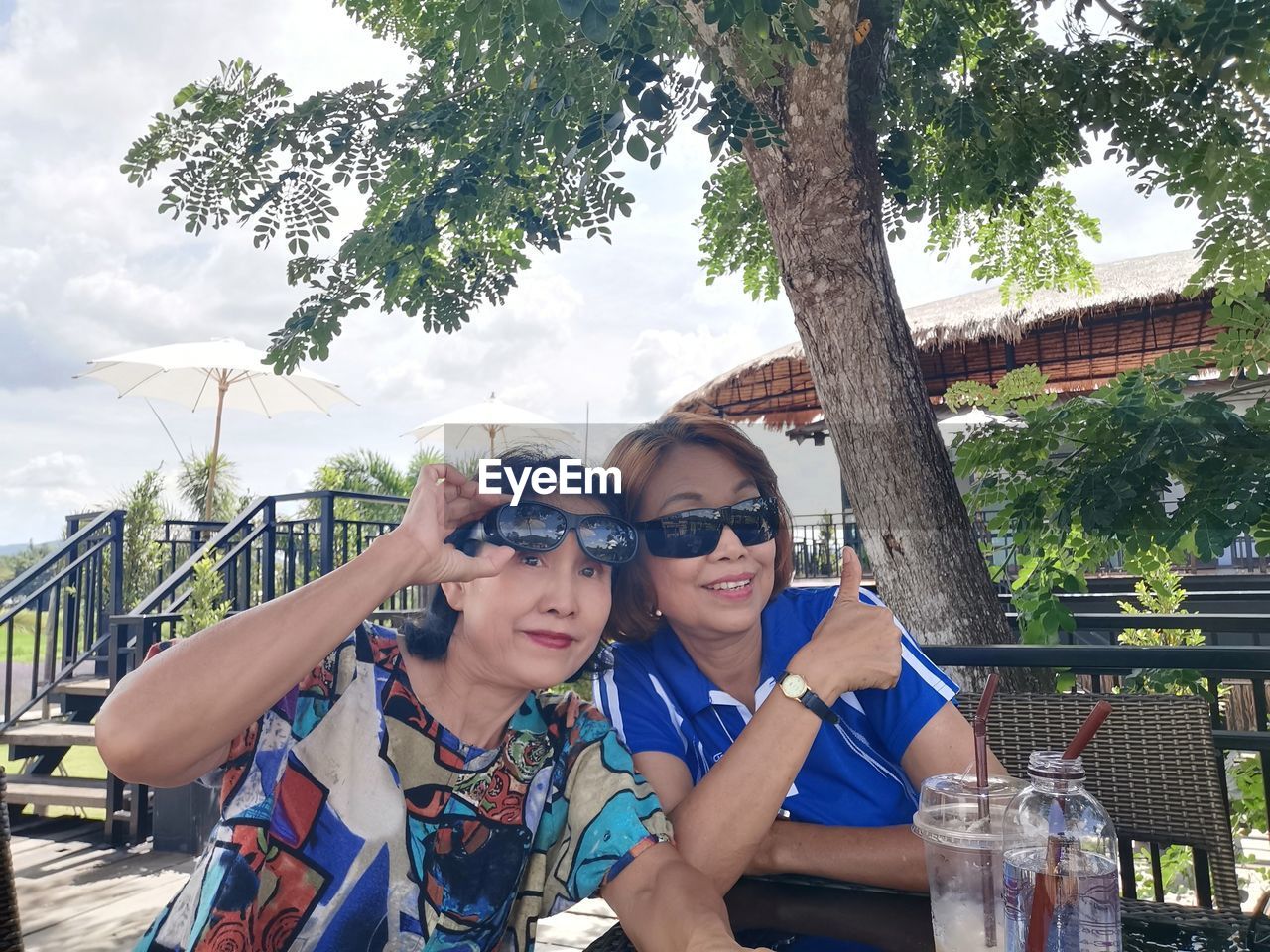 Portrait of women sitting at restaurant outdoors