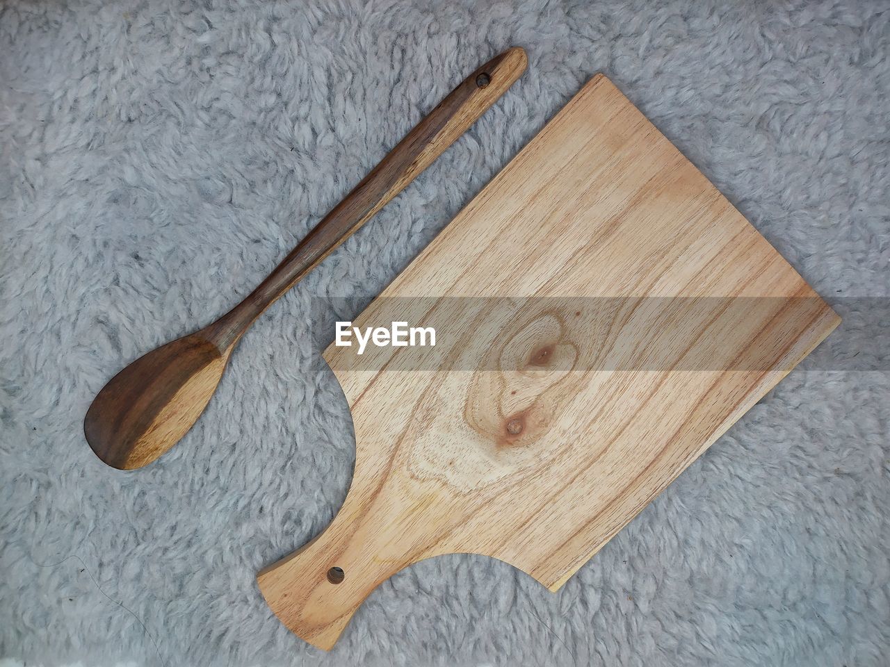 High angle view of wooden spoon and cutting board