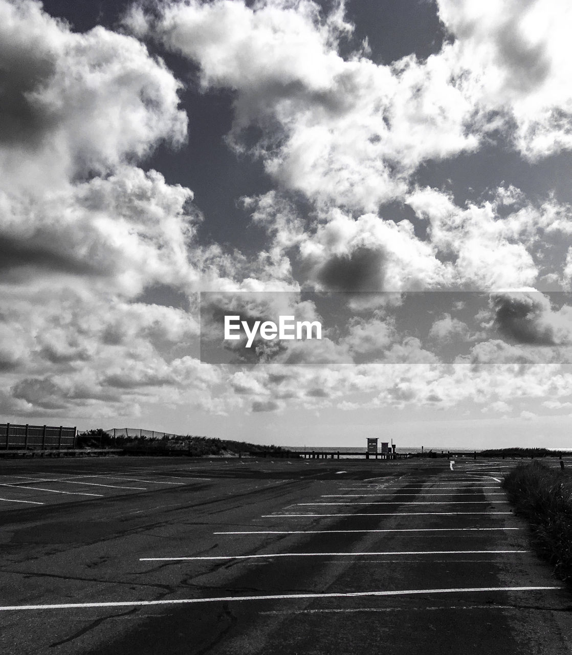 Empty parking lot against sky at beach in black and the white