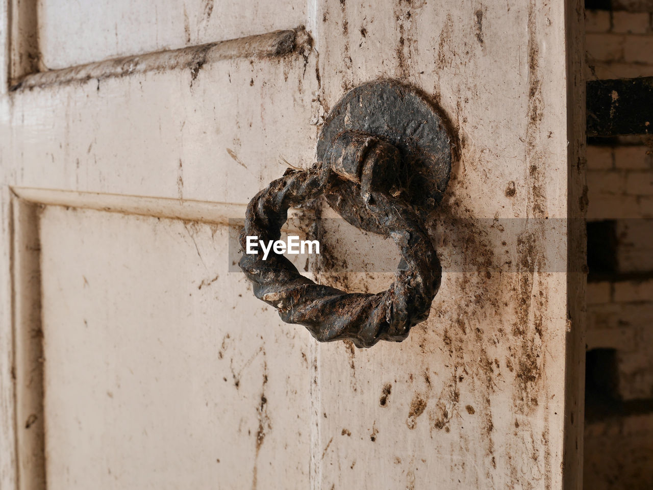 Exterior door with dirty rusted handle.