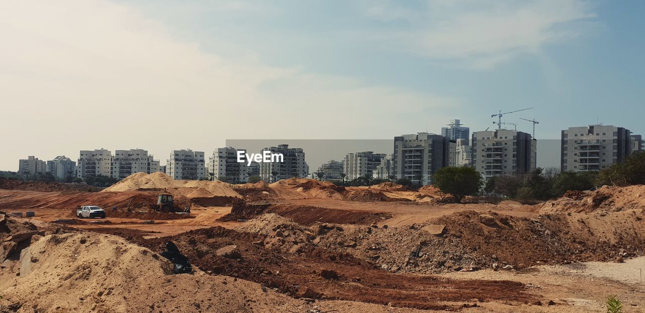 Panoramic shot of buildings against sky in city