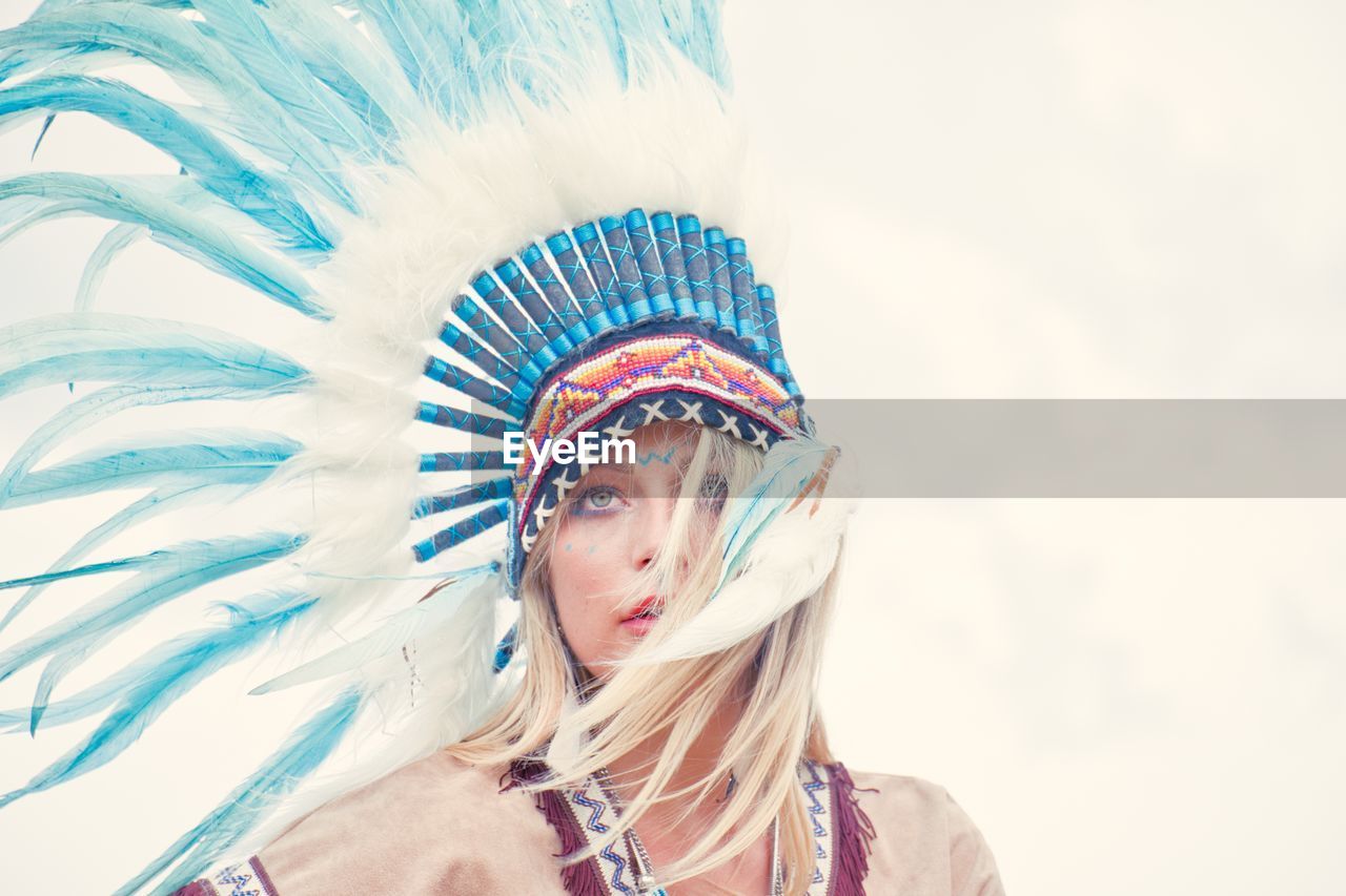 Young woman looking away while wearing headdress