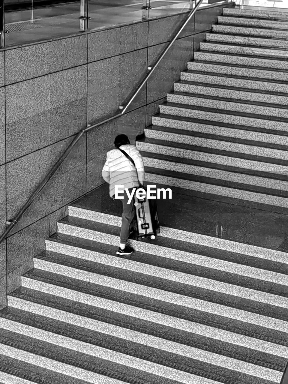 staircase, steps and staircases, one person, full length, architecture, men, railing, high angle view, lifestyles, black and white, walking, rear view, monochrome, day, leisure activity, casual clothing, transportation, monochrome photography, black, pedestrian crossing, city, line, built structure, women, the way forward, stairs, adult, outdoors, white, sunlight, person, childhood, pattern, road, child