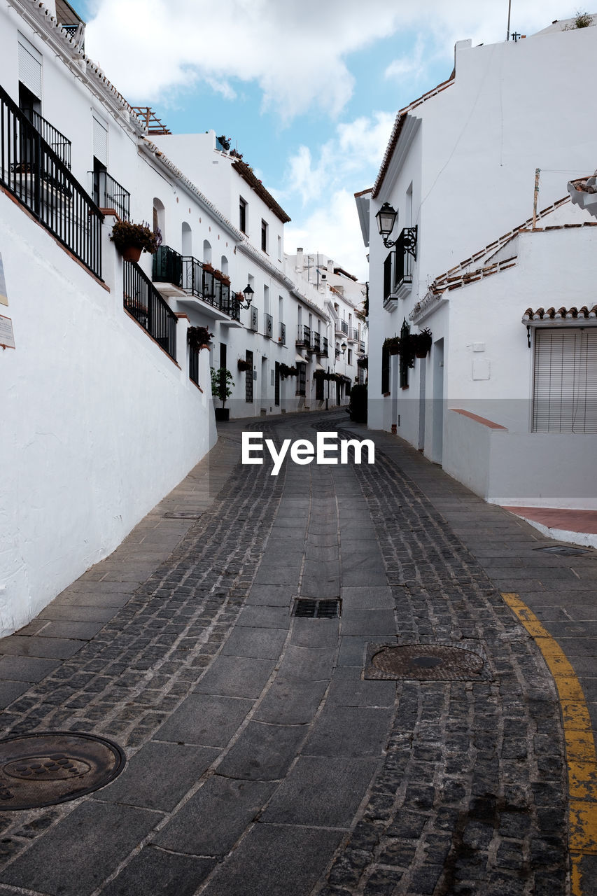 Empty alley amidst buildings in city