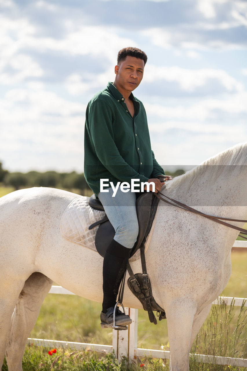 MAN RIDING A HORSE