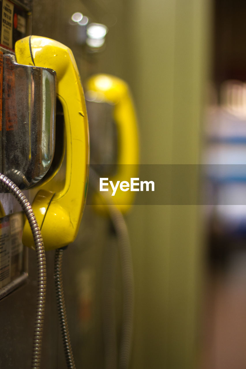 Close-up of yellow street phones