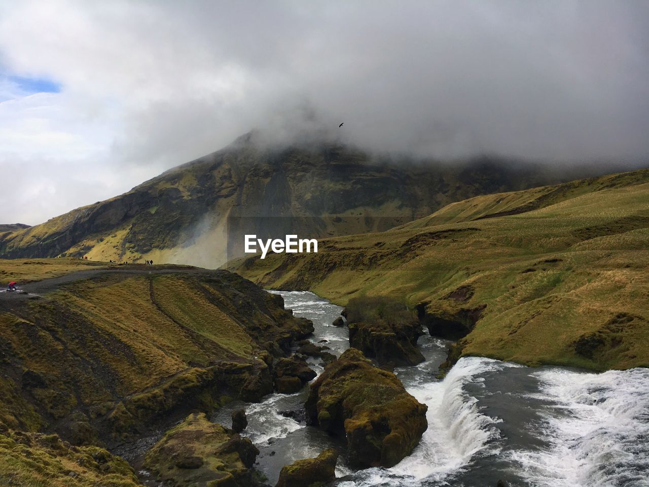 Scenic view of mountain against cloudy sky