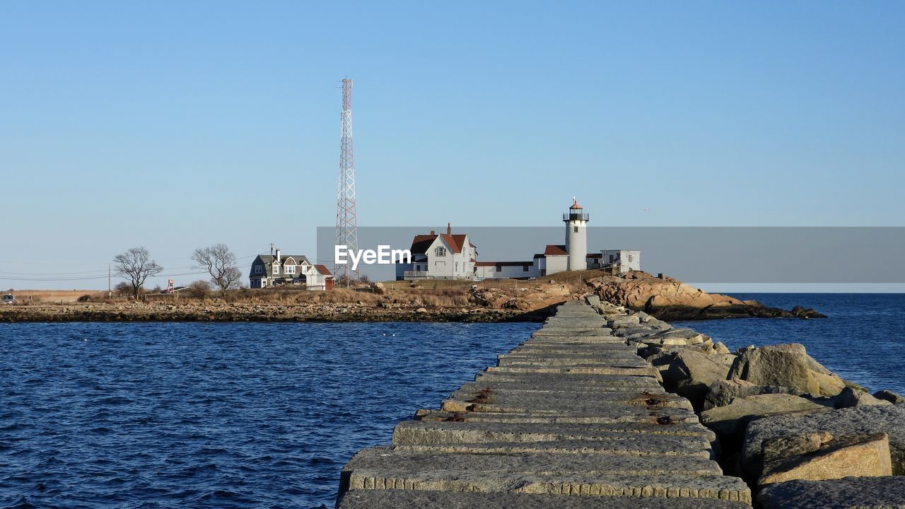 Eastern point lighthouse and breakwater in gloucester harbor