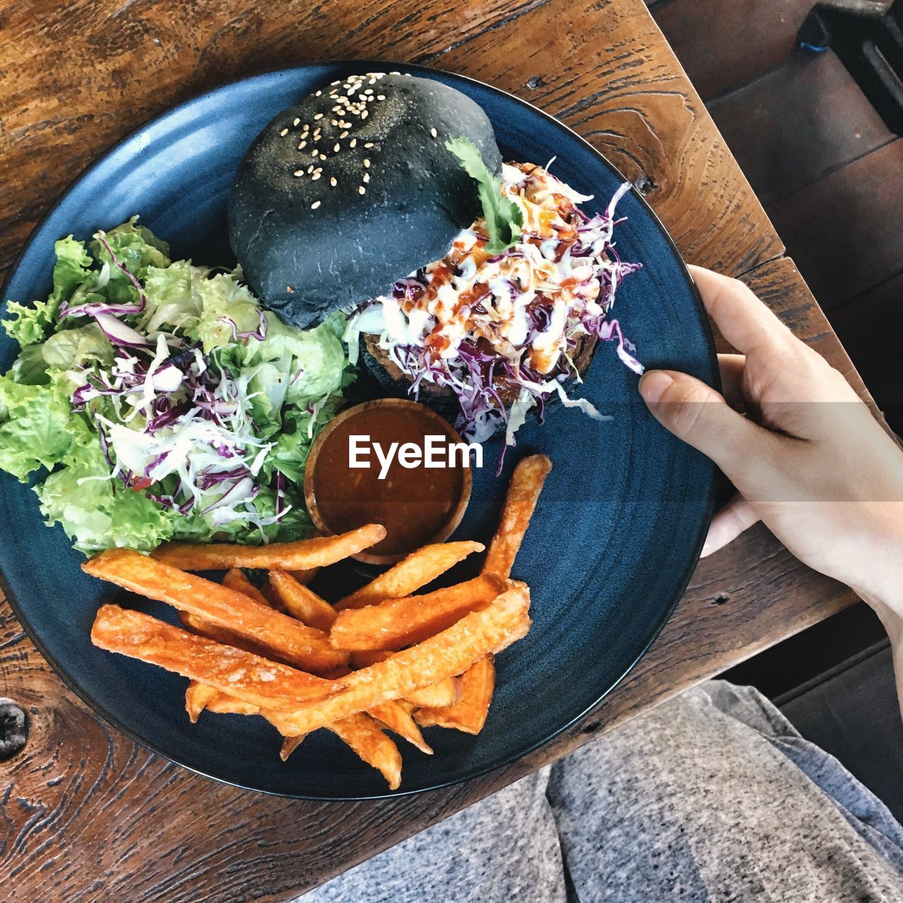 Cropped hand of person having food on table