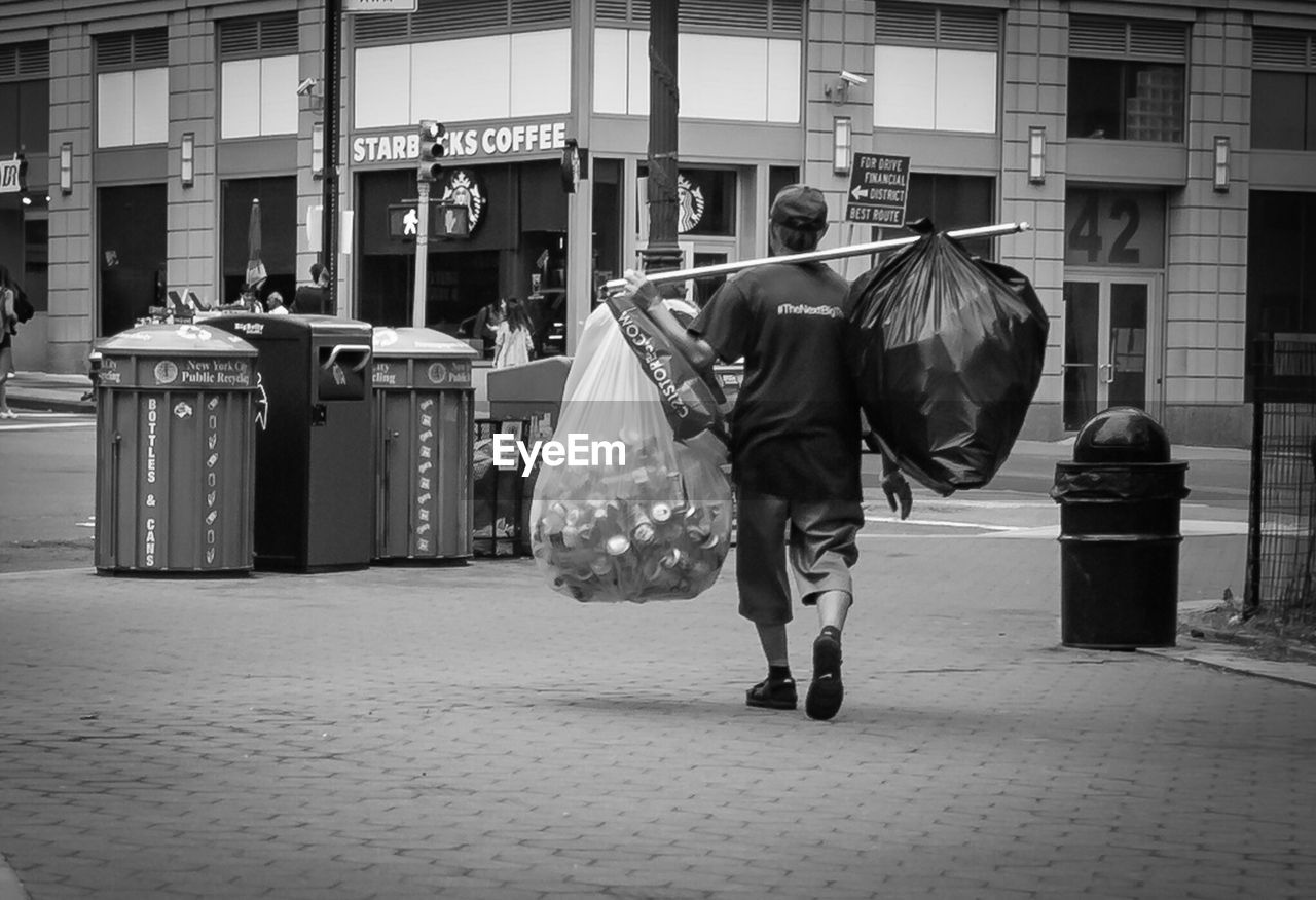 WOMAN STANDING IN CITY