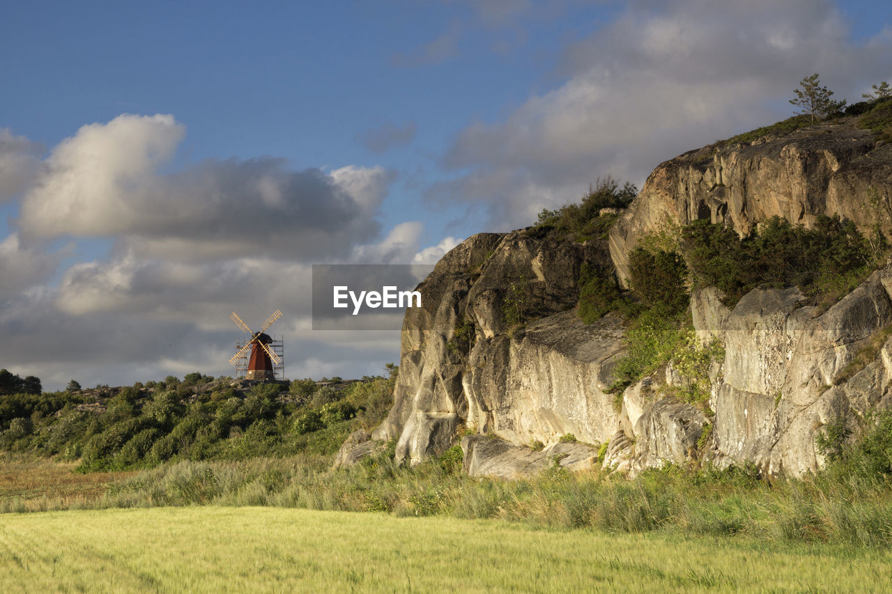 PANORAMIC VIEW OF ROCK FORMATIONS ON FIELD AGAINST SKY