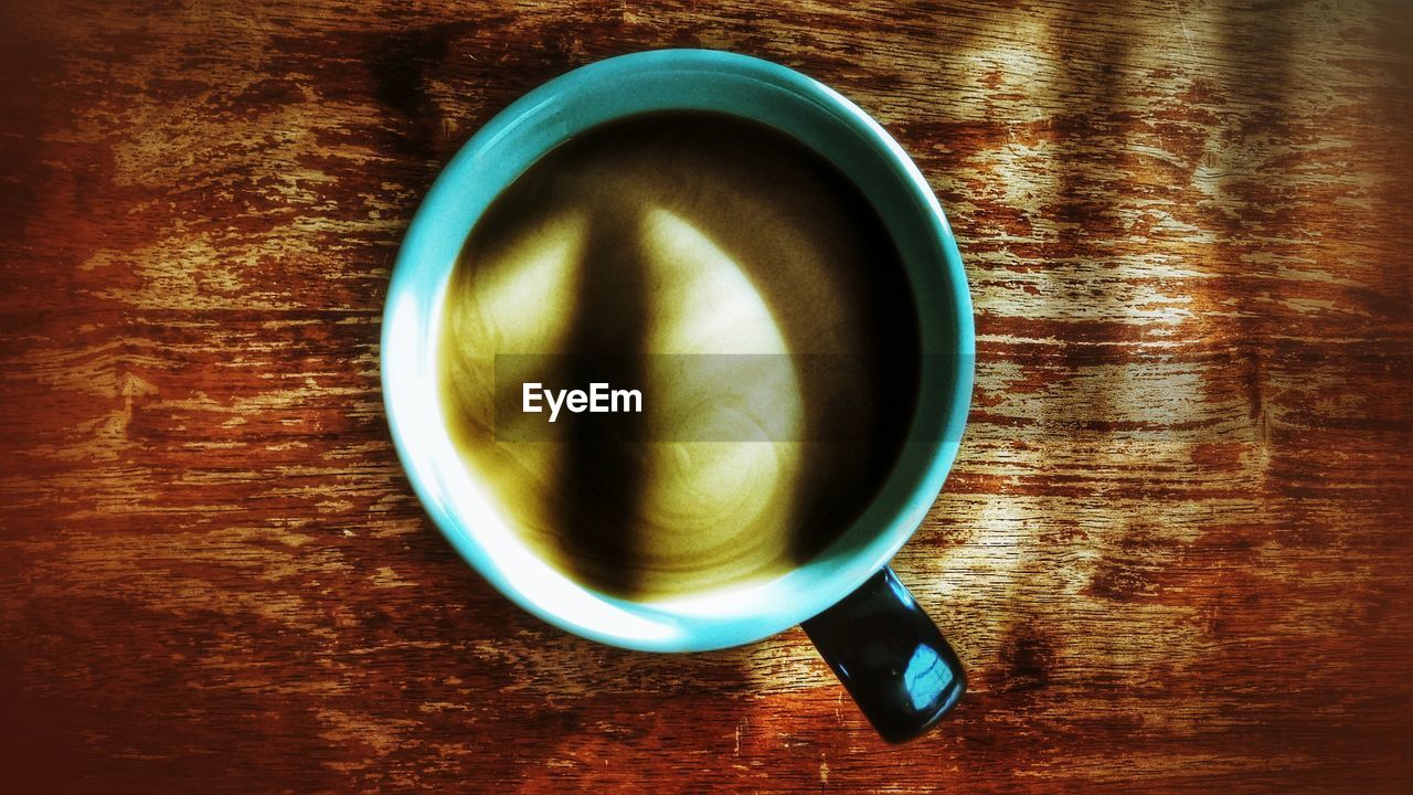 Close-up of coffee in cup on wooden table
