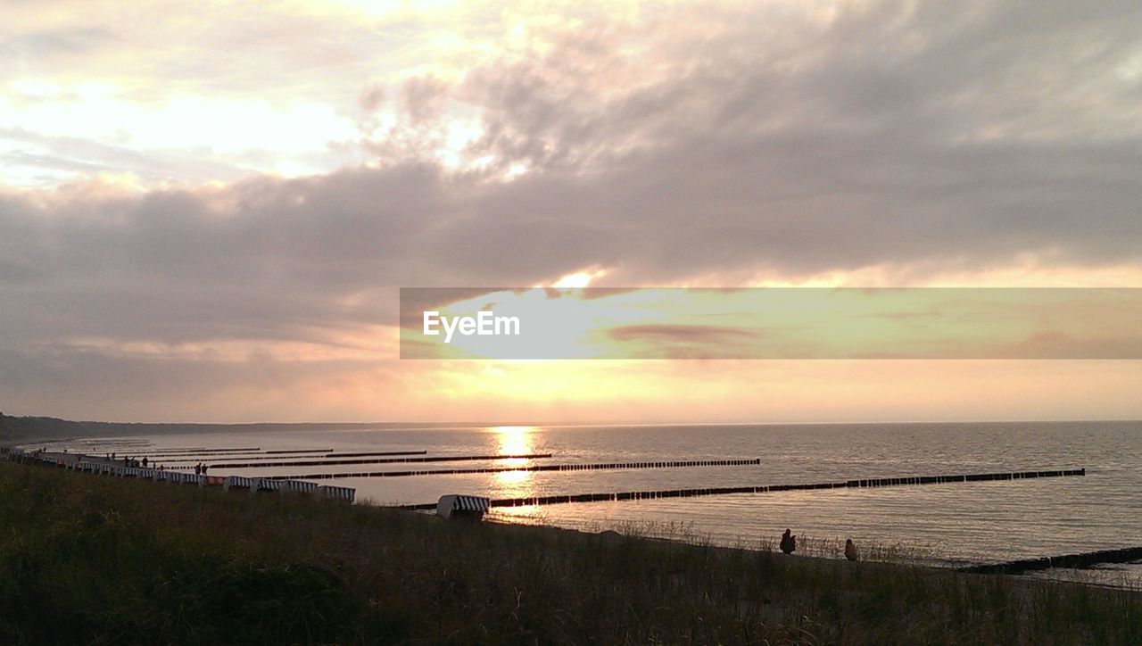 View of calm beach at sunset