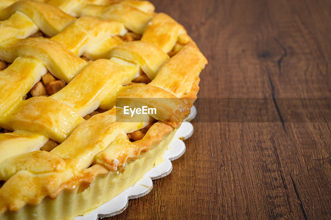 food, food and drink, freshness, dish, sweet food, wood, dessert, baked, indoors, sweet, produce, table, no people, apple pie, fruit, healthy eating, close-up, still life, pie, cuisine, pastry, sweet pie, fast food, yellow, snack, high angle view