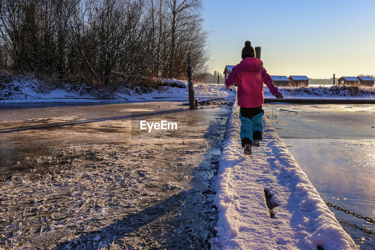 Boy crossing frozen river