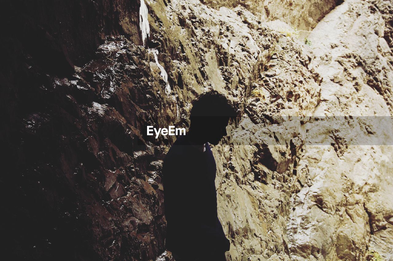 Man standing against rock formation