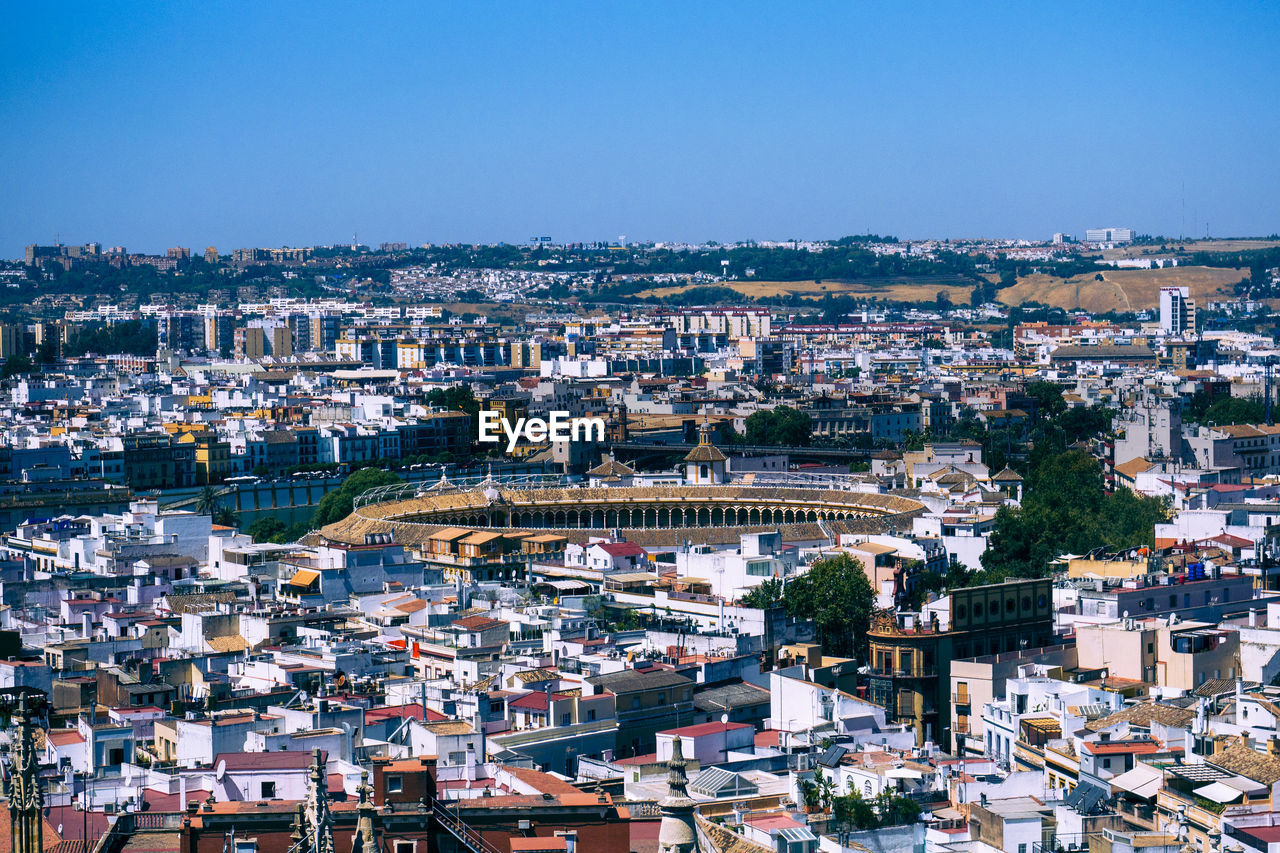 High angle view of townscape against blue sky